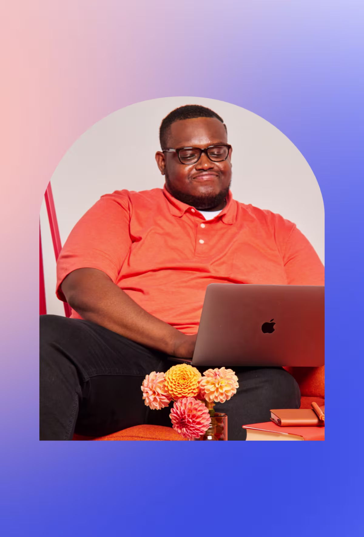 Image of a smiling man with a laptop